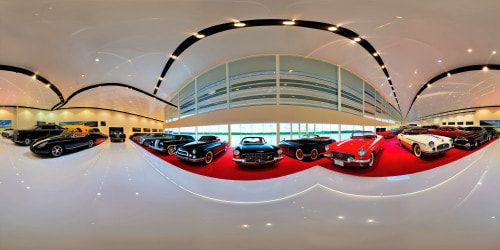A prestigious car show displaying a lineup of gleaming, flawless, ultra high-resolution masterpiece cars from a variety of eras and styles, under radiant studio lighting, each casting intricate reflections on a polished showroom floor.