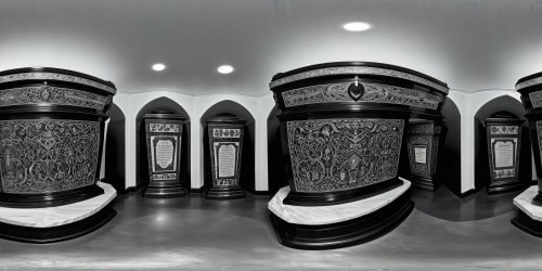 Crafted from flawless polished mahogany, an intricately carved coffin rests in a grand, ornate burial chamber, adorned with shimmering gold accents, soft candlelight casting gentle shadows, ensconced within a dimly lit ancient catacomb filled with solemn echoes, offering an atmosphere of reverent serenity in unparalleled ultra-high resolution beauty.