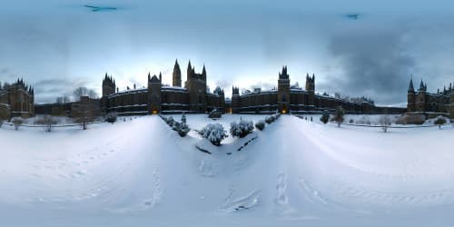 Facing the Renaissance Gothic castles. the castle's walls are gray and have breaches on it. in dark dim weather. little snow falls on the bricks. 