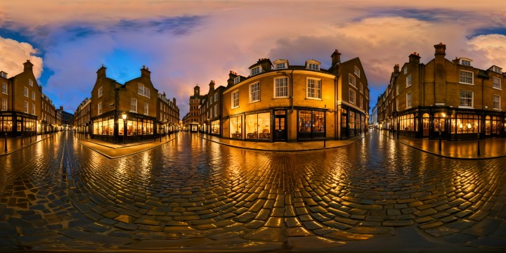 A flawless, museum-quality depiction of a London street shimmering in the November night, with rain-kissed cobblestones reflecting the ambient light of old-fashioned gas lamps, vibrant shop windows glowing warmly, surrounded by historic Victorian architecture, enveloped in a soft, misty rain, capturing the essence of a timeless, enchanting scene.